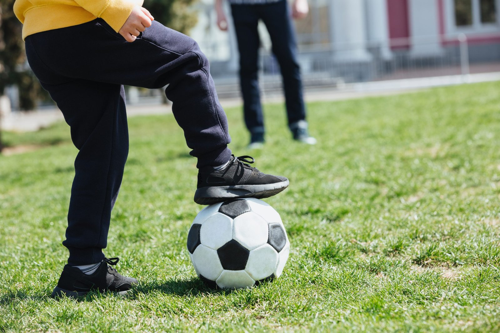 Home cropped image of a little boy with football playing