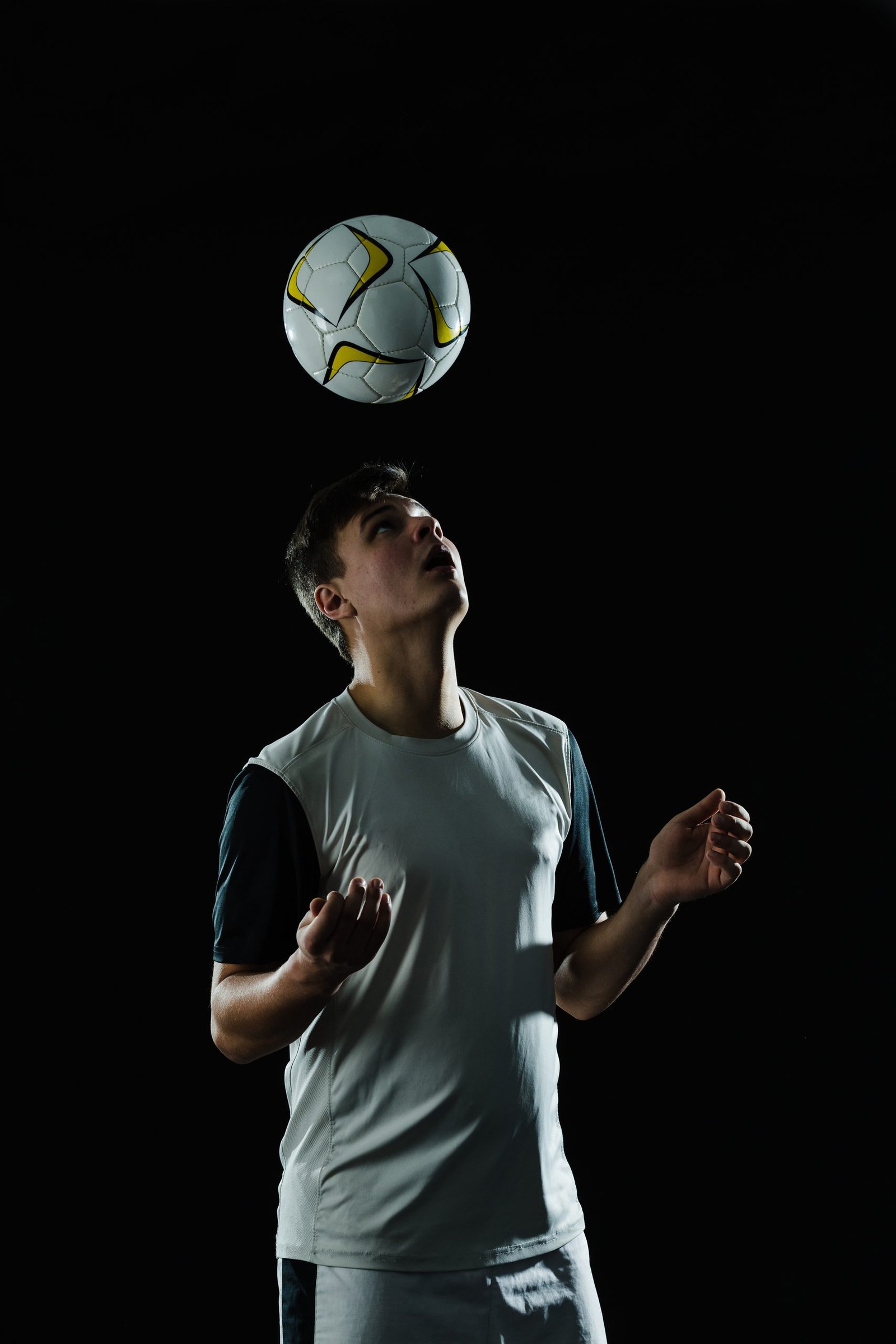 Home soccer player hitting ball with head
