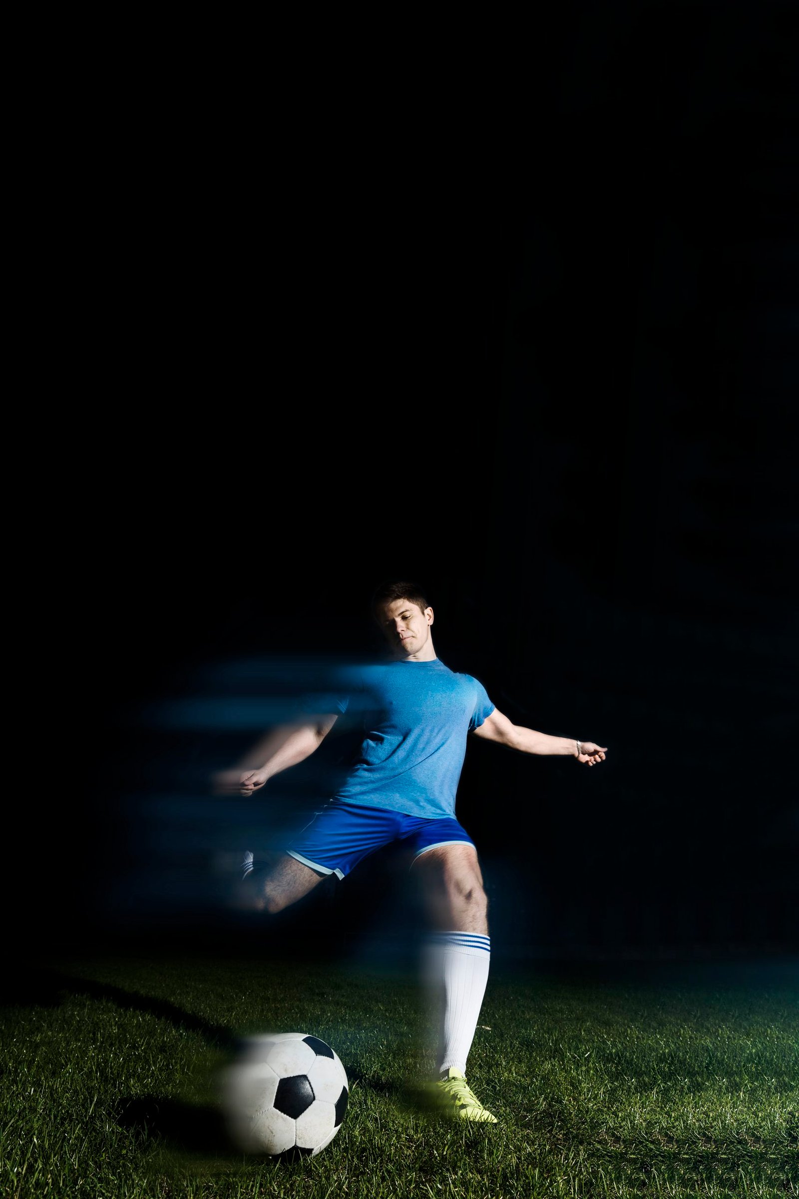 Home young sportsman kicking soccer ball